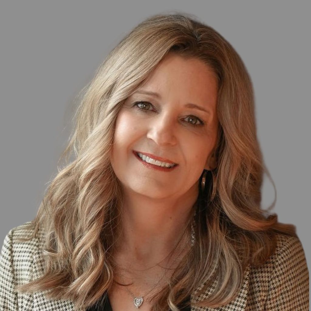 Professional headshot of Ronnie Wooten, featuring a warm smile and business attire against a neutral gray background.